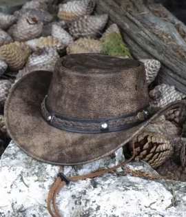 brown foldable leather hat sat on a stone background