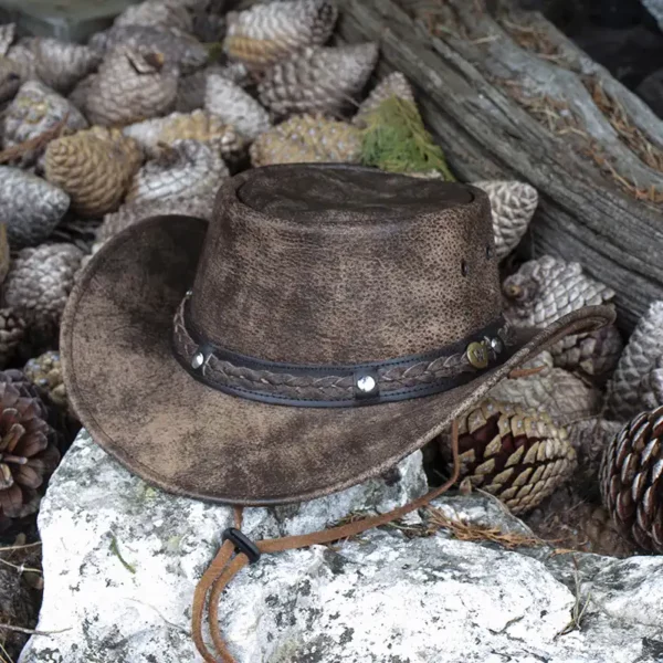 brown foldable leather hat sat on a stone background