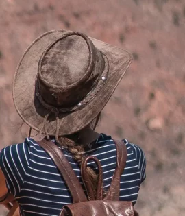 woman with a wilds hat and leather backpack from wombat