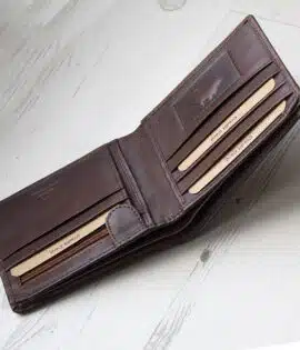 brown leather wallet with coin zipped pocket on wood background