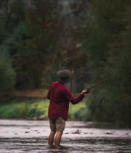 man wearing a waxed cotton hat fishing