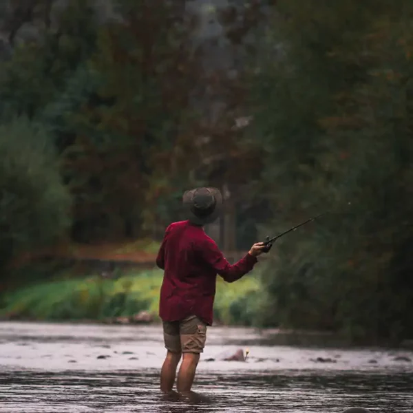 man wearing a waxed cotton hat fishing