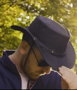 man wearing a black leather hat by wombat