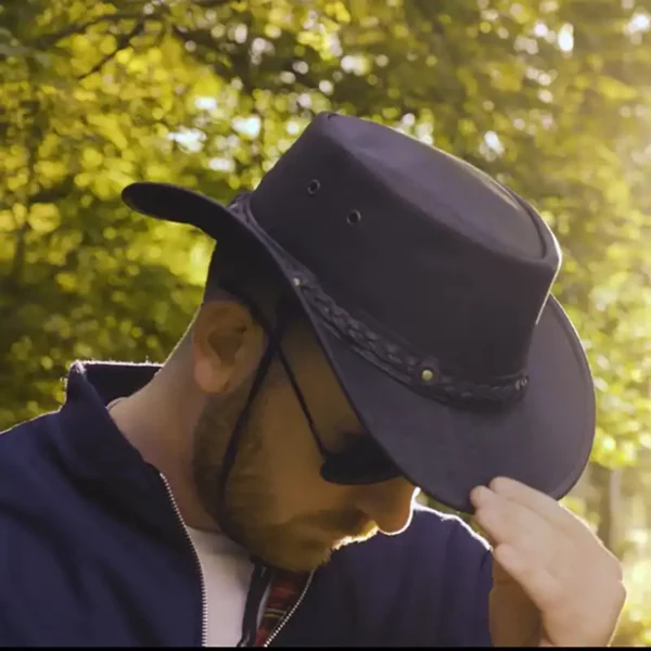 man wearing a black leather hat by wombat