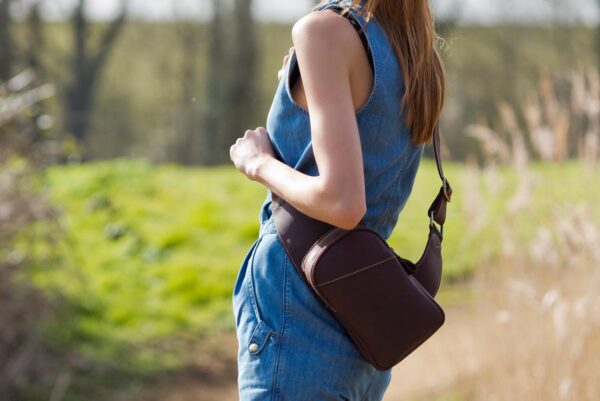 woman wearing a wombat Leather Sling Backpack Bag