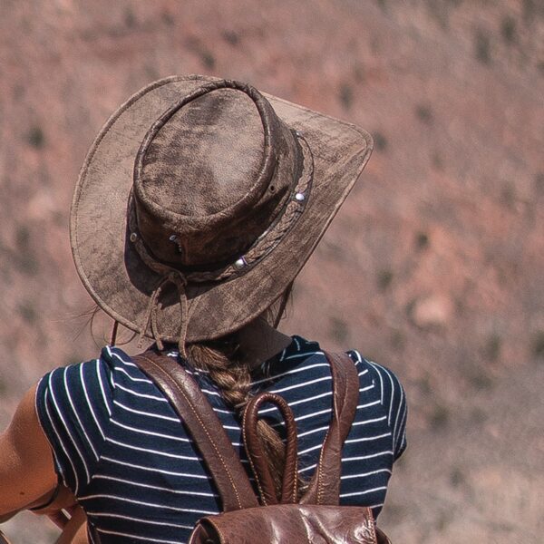 woman with a wilds hat and leather backpack from wombat