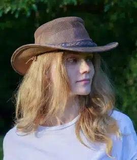 woman wearing a wombat the wilds air brown leather hat with mesh sides