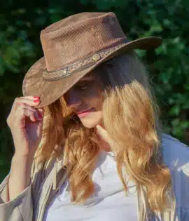 woman wearing a wombat the wilds air brown leather hat with mesh sides