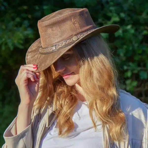 woman wearing a wombat the wilds air brown leather hat with mesh sides