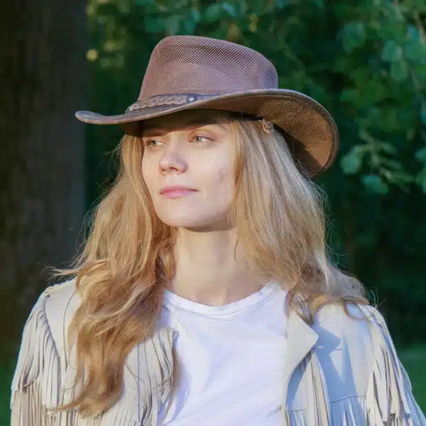 woman wearing a wombat the wilds air brown leather hat with mesh sides