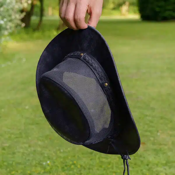 man holding a wombat the wilds air back leather hat with mesh sides