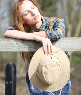 woman holding a wombat sand coloured wombat hat