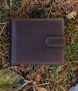 brown leather wallet on a grass and leaf background