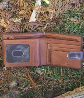 brown leather wallet on a grass and leaf background