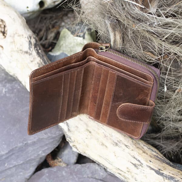 Womans brown vintage style leather bifold purse Wallet open showing card slots and note pockets