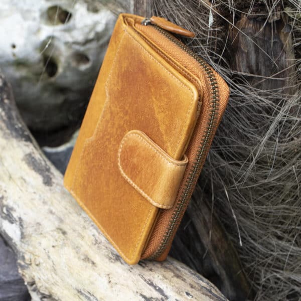 Womans Tan vintage style leather bifold purse Wallet with a tab opening side view showing metal zip purse section