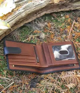 brown leather wallet on a grass and leaf background