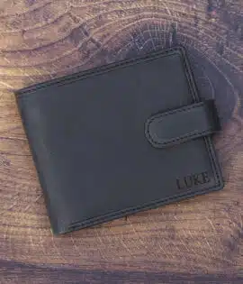 black leather wallet on a wood background with laser embossing