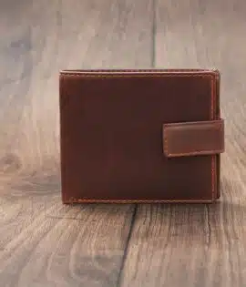 mens tan bifold wallet on a wood background