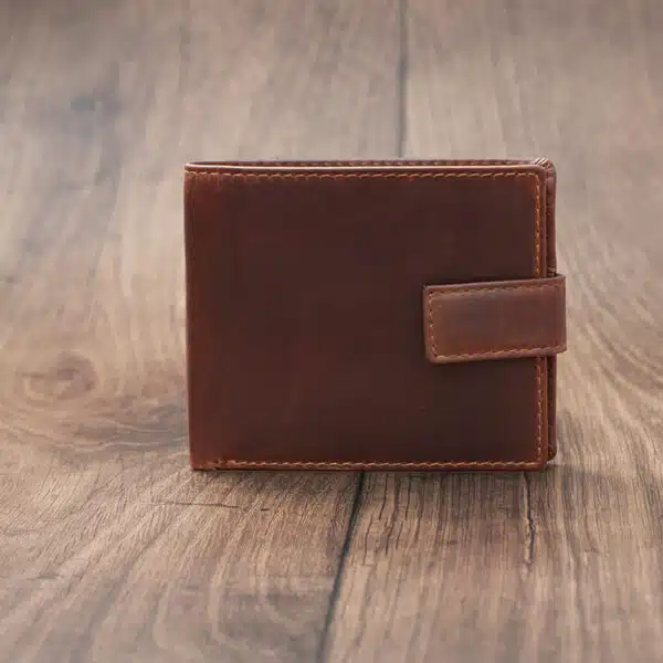 mens tan bifold wallet on a wood background