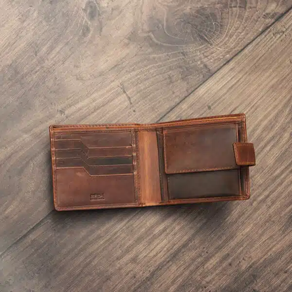 mens tan bifold wallet on a wood background open