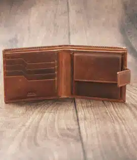 mens tan bifold wallet on a wood background open