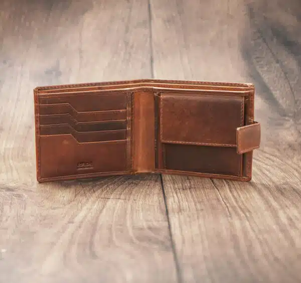 mens tan bifold wallet on a wood background open