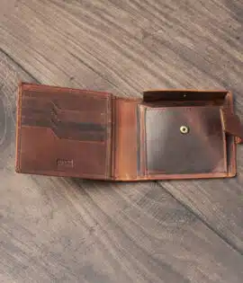 mens tan bifold wallet on a wood background open showing popper change pocket