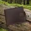 brown leather wallet on a grass on woodland log by wombat outdoor
