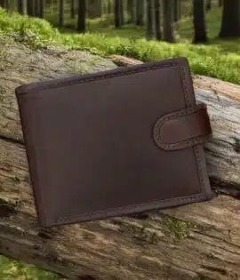 brown leather wallet on a grass on woodland log by wombat outdoor