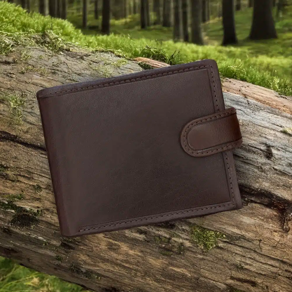brown leather wallet on a grass on woodland log by wombat outdoor