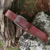 tan leather belt on wood and stone background