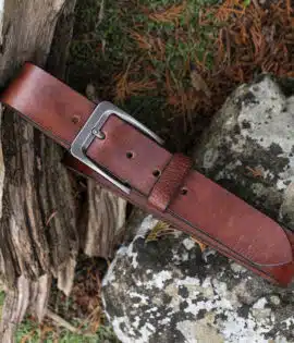 tan leather belt on wood and stone background