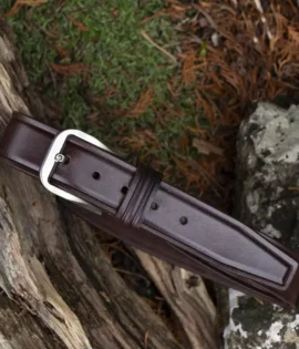 brown leather belt on wood and stone background