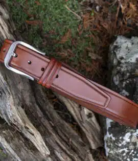 tan leather belt on wood and stone background