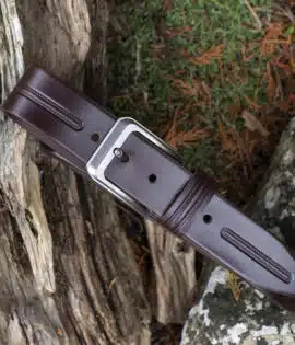 brown leather belt on wood and stone background