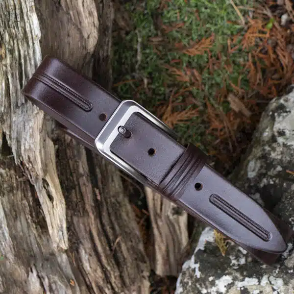 brown leather belt on wood and stone background