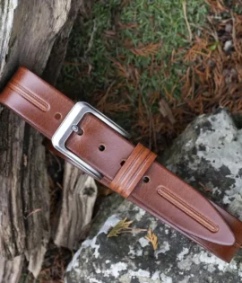 tan leather belt on wood and stone background