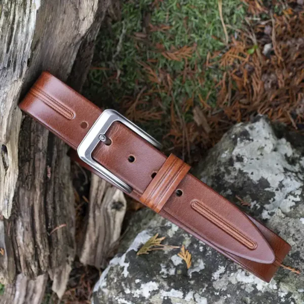 tan leather belt on wood and stone background