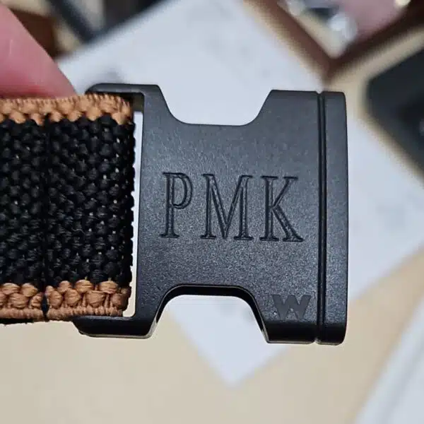 embossed initials on a belt buckle