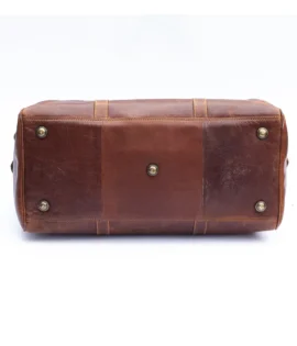 Wombat men’s brown leather travel bag with brass details BOTTM VIEW SHOWING THE BRASS FEET
