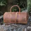 HUNTER LEATHER travel bag holdall on a log