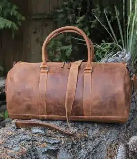 HUNTER LEATHER travel bag holdall on a log