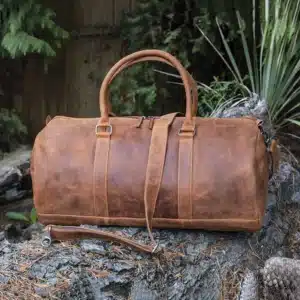 HUNTER LEATHER travel bag holdall on a log
