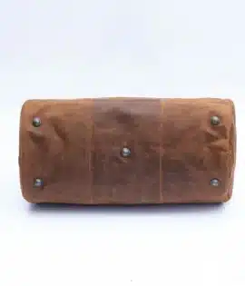 Brown soft leather weekend duffle bag shoing the brass feet to protect the bottom of the bag