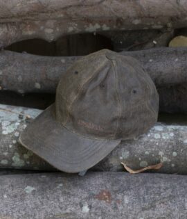 wombat soft distressed leather outdoor cap on a wooden log