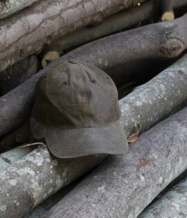 wombat soft distressed leather outdoor cap on a wooden log