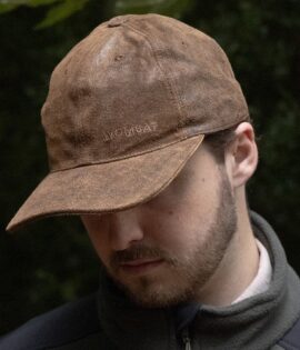 man wearing a brown leather cap by wombat