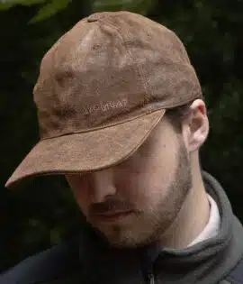 man wearing a brown leather cap by wombat