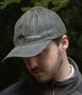 man wearing a green leather cap by wombat